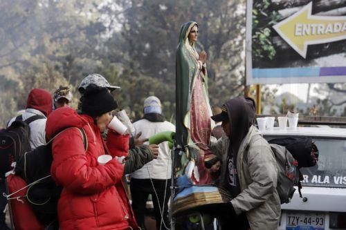epa12581907 A person carries a religious image during a pilgrimage to the Basilica of Guadalupe in Paso de Cortes mountain pass in Puebla state, Mexico, 09 December 2025. Hundreds of Mexican faithful began their annual pilgrimage to the Shrine of the Virgin of Guadalupe this week, which is expected to draw millions of visitors marking the 494th anniversary...