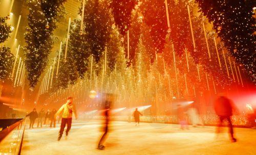 epa12585132 People skate on an ice rink in the art installation 'Forest - Winterlights 2025' by light and media artist Christopher Bauder at his Dark Matter art gallery in Berlin, Germany, 11 December 2025. Berlin-based light and media artist Bauder has created a poetic forest landscape covering 1,000 square metres, featuring over 600 trees, most of which...