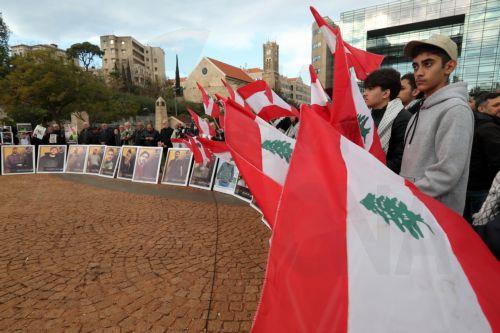 epa12587533 Activists and relatives of detainees in Israeli prisons carry pictures of the Lebanese prisoners in Israeli jails, during a protest outside the United Nations Economic and Social Commission for Western Asia (UN-ESCWA) headquarters in Beirut, Lebanon, 12 December 2025. Activists and relatives of detainees in Israeli prisons gather for a protest...
