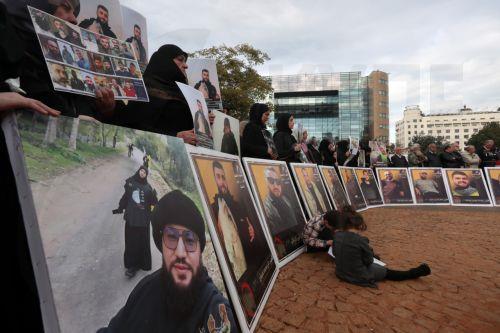 epa12587535 Activists and relatives of detainees in Israeli prisons carry pictures of the Lebanese prisoners in Israeli jails, during a protest outside the United Nations Economic and Social Commission for Western Asia (UN-ESCWA) headquarters in Beirut, Lebanon, 12 December 2025. Activists and relatives of detainees in Israeli prisons gather for a protest...