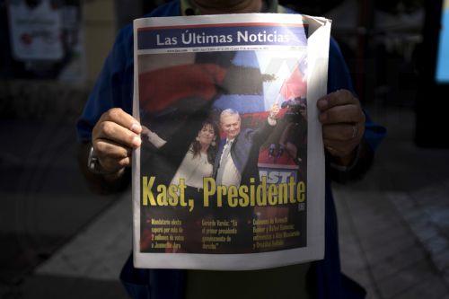 epa12594403 A person holds a newspaper announcing the results of the presidential elections in Santiago, Chile, 15 December 2025. The far-right Jose Antonio Kast won the second round of the presidential elections in Chile on 14 December.  EPA/ADRIANA THOMASA