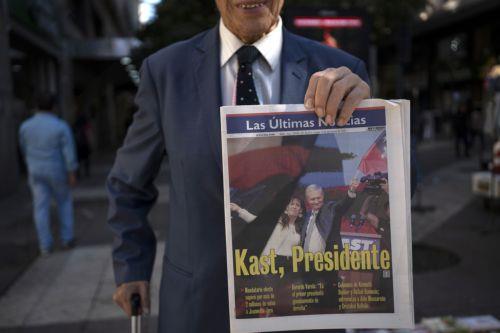 epa12594404 A man holds a newspaper announcing the results of the presidential elections in Santiago, Chile, 15 December 2025. The far-right Jose Antonio Kast won the second round of the presidential elections in Chile on 14 December.  EPA/ADRIANA THOMASA