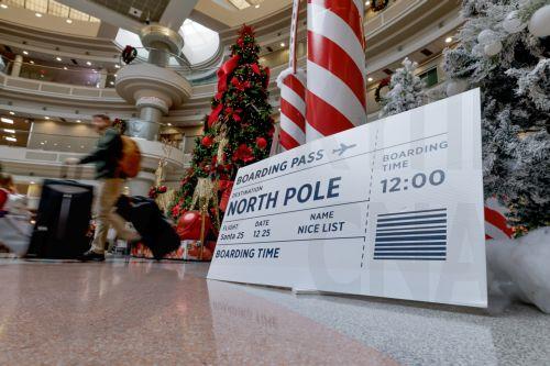 epa12609413 Holiday decorations greet air passengers transiting through Hartsfield-Jackson Atlanta International Airport during the busy Christmas holiday travel season in Atlanta, Georgia, USA, 22 December 2025. Weather could cause delays for both air travelers and drivers.  EPA/ERIK S. LESSER