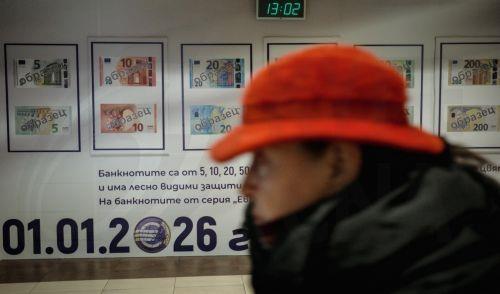 epa12616780 A woman passes a euro adoption poster in Sofia, Bulgaria, 29 December 2025. Bulgaria is set to become the 21st member of the eurozone on 01 January 2026, transitioning from the national lev to the euro amid public concerns that the move could trigger immediate price hikes and a higher cost of living.  EPA/BORISLAV TROSHEV