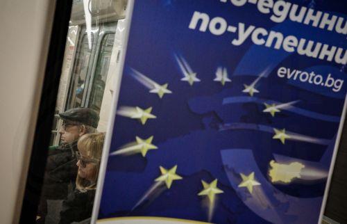 epa12616785 People ride the subway next to a euro adoption poster in Sofia, Bulgaria, 29 December 2025. Bulgaria is set to become the 21st member of the eurozone on 01 January 2026, transitioning from the national lev to the euro amid public concerns that the move could trigger immediate price hikes and a higher cost of living.  EPA/BORISLAV TROSHEV
