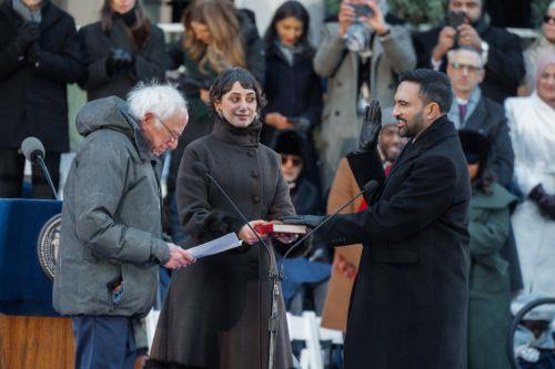 epaselect epa12621211 New York City Mayor Zohran Mamdani (R) raises his right hand while being sworn in by US Senator Bernie Sanders (L) during his inauguration ceremony in New York, New York, USA, 01 January 2026.  EPA/OLGA FEDOROVA