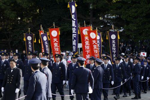 epa12621335 Police officers escort well-wishers arriving for the New Year's public appearance of the Japanese Imperial Family at the Imperial Palace in Tokyo, Japan, 02 January 2026. People gathered at the Imperial Palace for the traditional New Year greetings by the Japanese Imperial Family.  EPA/KIYOSHI OTA