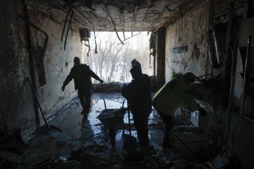 epaselect epa12628344 Ukrainians clear debris at the site of a Russian drone strike on a private medical clinic in Kyiv, Ukraine, 05 January 2026, amid the Russian invasion. At least one person was killed and three others were injured as a result of the attack, according to the State Emergency Service of Ukraine.  EPA/SERGEY DOLZHENKO