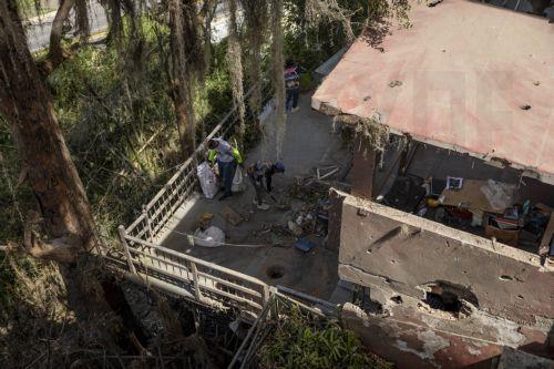 epa12632542 Government workers clean debris from a house damaged by the US attack in Caracas, Venezuela, 06 January 2026. Broken glass, bullet holes, dust, and paint remnants cover furniture and floors in several homes in a Caracas neighborhood affected by the US attack last 03 January, which culminated in the capture of President Nicolas Maduro and his...