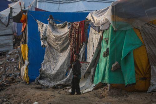 epa12632561 An internally displaced Palestinian boy plays next his family shelter at Al Rashid road in the west of Gaza City on, 06 January 2026, amid a ceasefire between Israel and Hamas. Around 1.9 million people in Gaza, nearly 90 percent of the population, have been displaced since the Israel-Hamas conflict began in October 2023, according to the UN. ...
