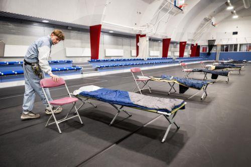 epaselect epa12636162 A person works to set up a temporary shelter for the homeless in the Hogendorphal sports center in Amsterdam, The Netherlands, 08 January 2026. Every spot in the standard shelters is occupied due to lot of snow and the chilly nights.  EPA/SIMON LENSKENS