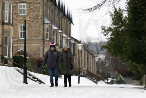 epa12637954 People walk through snow in the Pavilion Gardens in Buxton, Britain, 09 January 2026. Met Office yellow and amber warnings for ice, snow and wind remain in force across much of Britain after Storm Goretti, the first named storm of the year, brought heavy snowfall and strong winds.  EPA/ADAM VAUGHAN