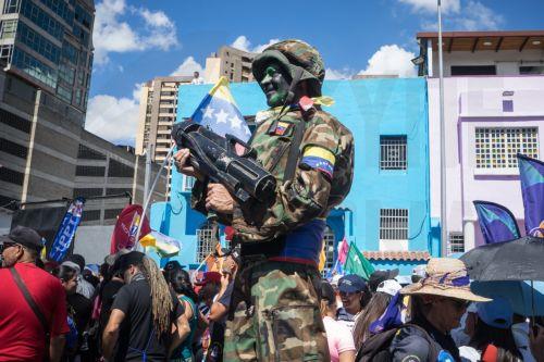 epa12639420 A person dressed in military clothing stands during a demonstration in Caracas, Venezuela, 09 January 2026. Supporters of Venezuelan President Nicolas Maduro called for his release after he and his wife, Cilia Flores, were captured by US forces during a military operation on 03 January 2026. Maduro and Flores are being held in the United States...