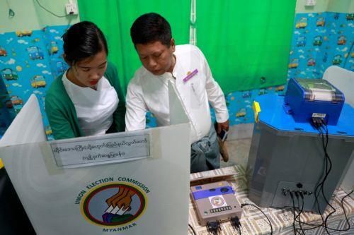 epa12639795 A volunteer and an officer of the Union Election Commission (UEC) set up an electronic voting machine at a polling station, one day ahead of the second phase of election in Yangon, Myanmar, 10 January 2026. Myanmar's military government, known as the State Administration Council (SAC), plans to hold its first national vote since the February...