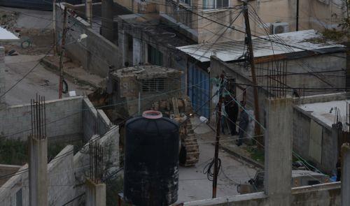 epa12644865 Palestinians watch Israeli army bulldozers during a military operation in Nur Shams refugee camp, near the West Bank city of Tulkarem, 12 January 2026. Israeli troops continue their operation in the Nur Shams refugee camp, east of Tulkarem, which has been under a tight Israeli siege since January 2025.  EPA/ALAA BADARNEH