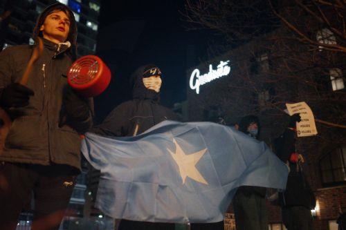 epa12647874 Protesters make noise and hold anti-ICE signs outside a Hilton hotel thought to house federal agents in Minneapolis, Minnesota, USA, 13 January 2026. As part of a federal immigration crackdown involving over 2,000 agents from Border Patrol, Immigration and Customs Enforcement (ICE), and Homeland Security Investigations (HSI), an ICE officer...