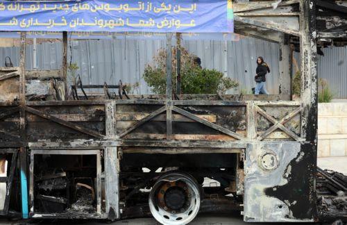 epa12650628 The wreckage of a burnt-out public bus in Tehran, Iran, 15 January 2026. The country remains under a near-total nationwide internet blackout that began on 08 January, amid an intensifying wave of anti-government protests.  EPA/ABEDIN TAHERKENAREH