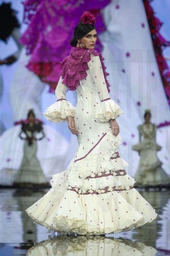 epa12690212 A model takes to the catwalk with some creations by Huelva's region designers under the motto 'Flamenco by Nature' during the International Flamenco Fashion Week held in Seville, Spain, on 29 January 2026.  EPA/Raul Caro