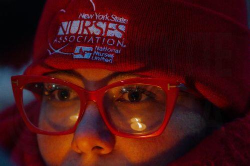 epa12691776 A person holds a candle during a vigil for Veterans Affairs (VA) nurse Alex Pretti outside a VA hospital in New York, New York, USA, 29 January 2026. Nationwide protests continue after federal immigration operations in Minneapolis resulted in the fatal shootings of two US citizens, Renee Nicole Good and Alex Pretti.  EPA/OLGA FEDOROVA