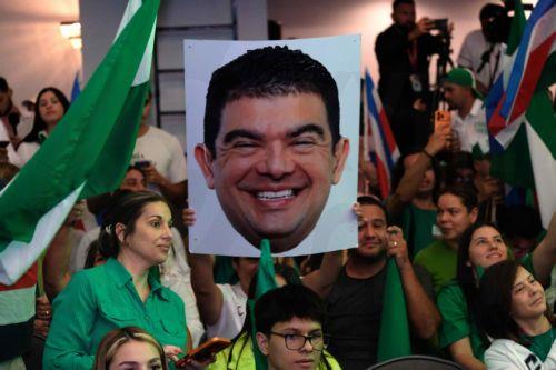 epa12699521 A supporter of the National Liberation Party holds a poster featuring Costa Rican presidential candidate Alvaro Garcia in San Jose, Costa Rica, 01 February 2026. Amid a festive atmosphere, Costa Ricans await the results of the elections, in which 3.7 million people were called to choose the country's president and the 57 deputies of the...