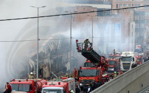 epa12701685 Firefighters try to control the fire at the Jannat shopping market in western Tehran, Iran, 03 February 2026. The cause of the fire is unclear.  EPA/ABEDIN TAHERKENAREH