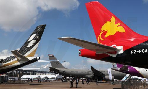 epa12701934 Visitors walk past aircrafts on static display during the Singapore Airshow at Changi Exhibition Centre, Singapore, 03 February 2026. The Singapore Airshow 2026, one of Asia’s largest aerospace and defense exhibitions, runs from 03 to 08 February.  EPA/HOW HWEE YOUNG