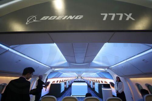 epa12701938 Visitors look at an exhibit featuring a full-size Boeing 777X interior section at the Boeing exhibition booth during the Singapore Airshow at Changi Exhibition Centre, Singapore, 03 February 2026. The Singapore Airshow 2026, one of Asia’s largest aerospace and defense exhibitions, runs from 03 to 08 February.  EPA/HOW HWEE YOUNG