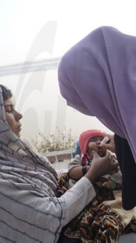 epa12703888 A health worker administers a polio vaccine to a child during a door-to-door vaccination campaign in Dera Ismail Khan, Pakistan, 04 February 2026. Pakistan launched its first nationwide anti-polio vaccination drive of the year, aiming to immunize more than 45 million children under the age of five between 02 and 08 February 2026. The campaign...