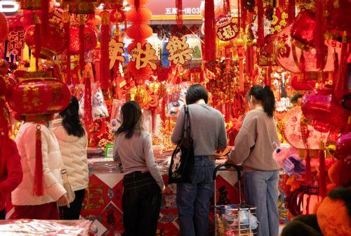 epa12719308 People browse decorations on sale amid preparations for the Chinese New Year in Beijing, China, 09 February 2026. The Chinese New Year, or Spring Festival, begins on 17 February, ushering in the Year of the Fire Horse with festivities running until the Lantern Festival on 03 March.  EPA/JESSICA LEE