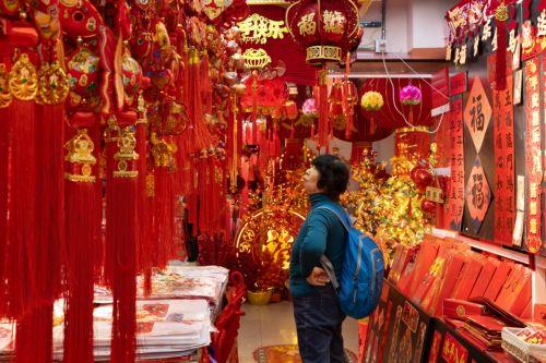 epa12719311 A person browses decorations on sale amid preparations for the Chinese New Year in Beijing, China, 09 February 2026. The Chinese New Year, or Spring Festival, begins on 17 February, ushering in the Year of the Fire Horse with festivities running until the Lantern Festival on 03 March.  EPA/JESSICA LEE