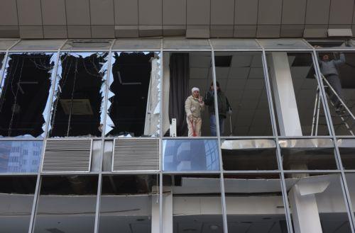 epa12719865 Ukrainian people inspect the damage at the site of a Russian strike in Odesa, southwestern Ukraine, 09 February 2026, amid the Russian invasion. At least one person was killed and two others injured after a drone hit a residential area, damaging a high-rise building and a gas pipeline, according to the State Emergency Service of Ukraine. ...