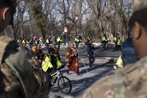 epa12725428 Bhikkhu Pannakara, a Theravada Buddhist monk, leads the Theravada Buddhist monks as they leave the Washington National Cathedral and move towards Embassy Row during the Walk For Peace in Washington, DC, USA, 10 February 2026. The Theravada Buddhist monks, who have walked from  Fort Worth, Texas, will make stops at the National Cathedral and...