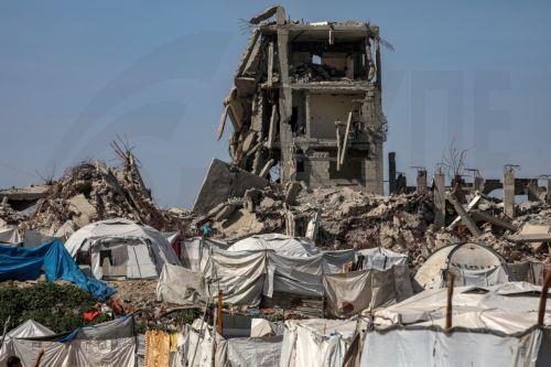 epa12731240 Makeshift tents of displaced Palestinian families among the ruins of the Al-Zaitun neighborhood of Gaza City, 12 February 2026, amid a ceasefire between Israel and Hamas. Despite an increase in humanitarian aid, the United Nations warned that the situation remains 'dire,' with children suffering from severe shortages of shelter, basic services,...