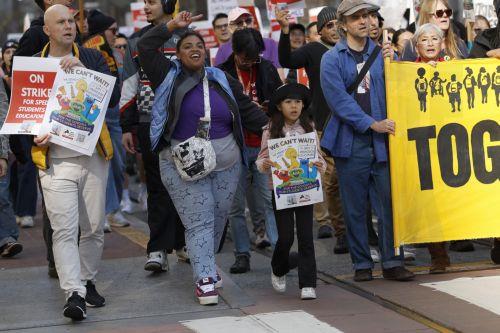 epa12732995 San Francisco Police block an intersection as San San Francisco teachers, educators and supporters rally and march as the teachers' strike enters its fourth day in San Francisco, California, USA, 12 February 2026. The San Francisco Unified School District (SFUSD) and union representatives continue negotiating a new contract as schools remain...