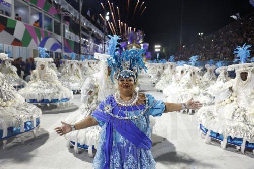 epa12745317 A member of the Portela samba school parades during the first day of the 2026 Rio Carnival at the Sambadrome in Rio de Janeiro, Brazil, 16 February 2026.  EPA/Antonio Lacerda