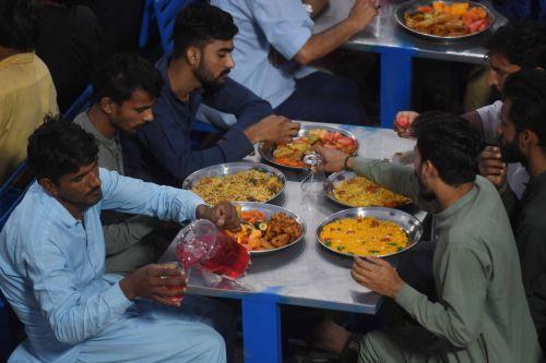 epa12758086 Pakistani people eat Iftar meals during the first day of the holy fasting month of Ramadan in Karachi, Pakistan, 19 February 2026. The Muslims' holy month of Ramadan, which start this year on 19 February in Pakistan, is the ninth month in the Islamic calendar, and it is believed that the revelation of the first verse in the Koran was during its...