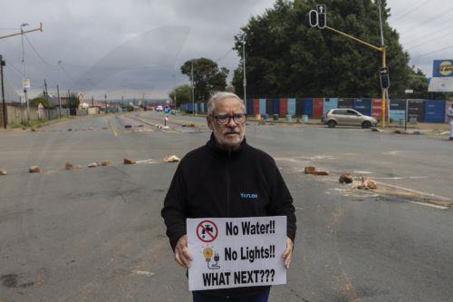 epa12772834 Residents from Coronationville and Westbury take to the streets to protest against the lack of water supply in many parts of Johannesburg, South Africa, 24 February 2026. The city is facing an increasingly dire water situation, with many areas already experiencing 'Zero Day' as their taps run dry. A combination of power supply issues, ailing...