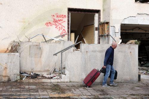 epaselect epa12786360 A man walks with his belongings after a building was struck by an Iranian missile in Tel Aviv, Israel, 01 March 2026. The Israeli military reported on 28 February it detected missiles launched from Iran following earlier Israeli and US strikes on Iran. Sirens were activated across several parts of the country in response.  EPA/ABIR...