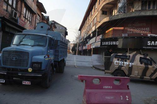 epa12788722 Indian paramilitary personnel stand guard behind barbed wire and barricades near the sealed city centre at Lal Chowk during restrictions in Srinagar, Kashmir, India, 02 March 2026. The authorities imposed severe restrictions a day after Shia Muslim demonstrators staged massive protests and assembled in the city centre near the iconic clock tower...