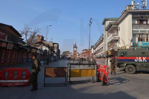 epa12788725 Indian police and paramilitary personnel stand guard behind a barricade near the sealed city centre at Lal Chowk during restrictions in Srinagar, Kashmir, India, 02 March 2026. The authorities imposed severe restrictions a day after Shia Muslim demonstrators staged massive protests and assembled in the city centre near the iconic clock tower in...