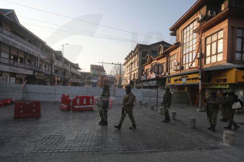 epa12788727 Indian paramilitary personnel patrol behind barbed wire and barricades near the sealed city centre at Lal Chowk during restrictions in Srinagar, Kashmir, India, 02 March 2026. The authorities imposed severe restrictions a day after Shia Muslim demonstrators staged massive protests and assembled in the city centre near the iconic clock tower in...