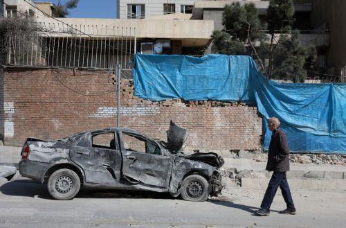 epa12793855 An Iranian man walks next to a damaged  building in central Tehran, Iran, 04 March 2026. A joint Israeli and US military operation continues to target multiple locations across Iran since the early hours of 28 February 2026.  EPA/ABEDIN TAHERKENAREH