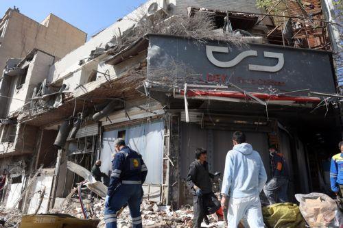 epa12793858 Iranians work next to a damaged pizza shop in central Tehran, Iran, 04 March 2026. A joint Israeli and US military operation continues to target multiple locations across Iran since the early hours of 28 February 2026.  EPA/ABEDIN TAHERKENAREH