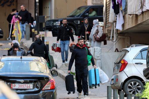 epa12805919 People carry their belongings after fleeing their homes following Israeli airstrikes in Beirut, Lebanon, 09 March 2026. The Israeli military stated it is conducting strikes across the country targeting Hezbollah infrastructure and personnel. According to the Disaster Management Unit of the Lebanese government, as of 08 March 2026, more than...