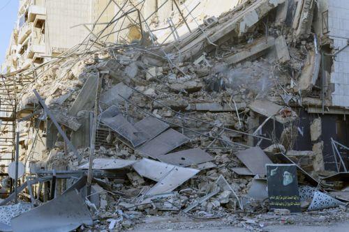 epa12807365 A picture of late Hezbollah leader Hassan Nasrallah sits over the rubble of a damaged building following an Israeli airstrike that targeted a branch of the Al-Qard Al-Hasan, a Hezbollah-affiliated financial institution, on the airport road in the southern suburbs of Beirut, Lebanon, 09 March 2026. The Israeli military stated it is conducting...