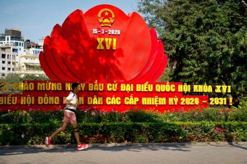 epa12808199 A man jogs past signage for the upcoming general election in Hanoi, Vietnam, 10 March 2026. Nearly 73.5 million voters in Vietnam are expected to cast ballots on 15 March to elect deputies to the 16th National Assembly and members of local People's Councils for the 2026–2031 tenure, according to state media.  EPA/LUONG THAI LINH