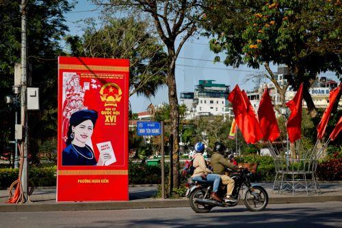 epa12808200 A man rides a motorbike past signage for the upcoming general election in Hanoi, Vietnam, 10 March 2026. Nearly 73.5 million voters in Vietnam are expected to cast ballots on 15 March to elect deputies to the 16th National Assembly and members of local People's Councils for the 2026–2031 tenure, according to state media.  EPA/LUONG THAI LINH