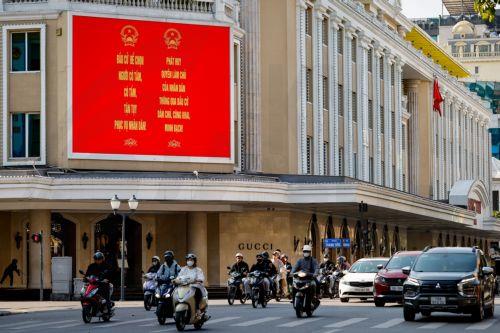 epa12808203 People ride motorbikes past signage for the upcoming general election in Hanoi, Vietnam, 10 March 2026. Nearly 73.5 million voters in Vietnam are expected to cast ballots on 15 March to elect deputies to the 16th National Assembly and members of local People's Councils for the 2026–2031 tenure, according to state media.  EPA/LUONG THAI LINH
