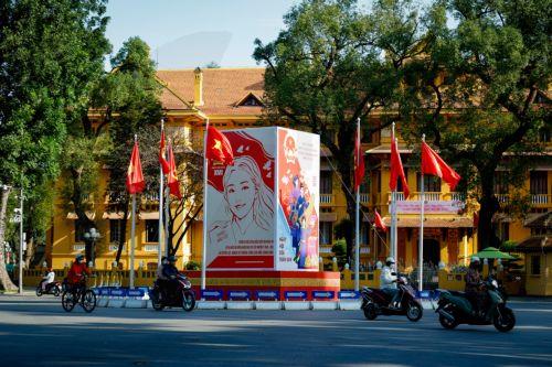 epa12808204 People ride motorbikes past signage for the upcoming general election in Hanoi, Vietnam, 10 March 2026. Nearly 73.5 million voters in Vietnam are expected to cast ballots on 15 March to elect deputies to the 16th National Assembly and members of local People's Councils for the 2026–2031 tenure, according to state media.  EPA/LUONG THAI LINH