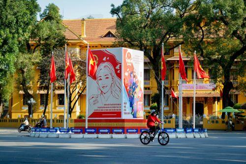 epa12808208 A woman rides a bicycle past signage for the upcoming general election in Hanoi, Vietnam, 10 March 2026. Nearly 73.5 million voters in Vietnam are expected to cast ballots on 15 March to elect deputies to the 16th National Assembly and members of local People's Councils for the 2026–2031 tenure, according to state media.  EPA/LUONG THAI LINH